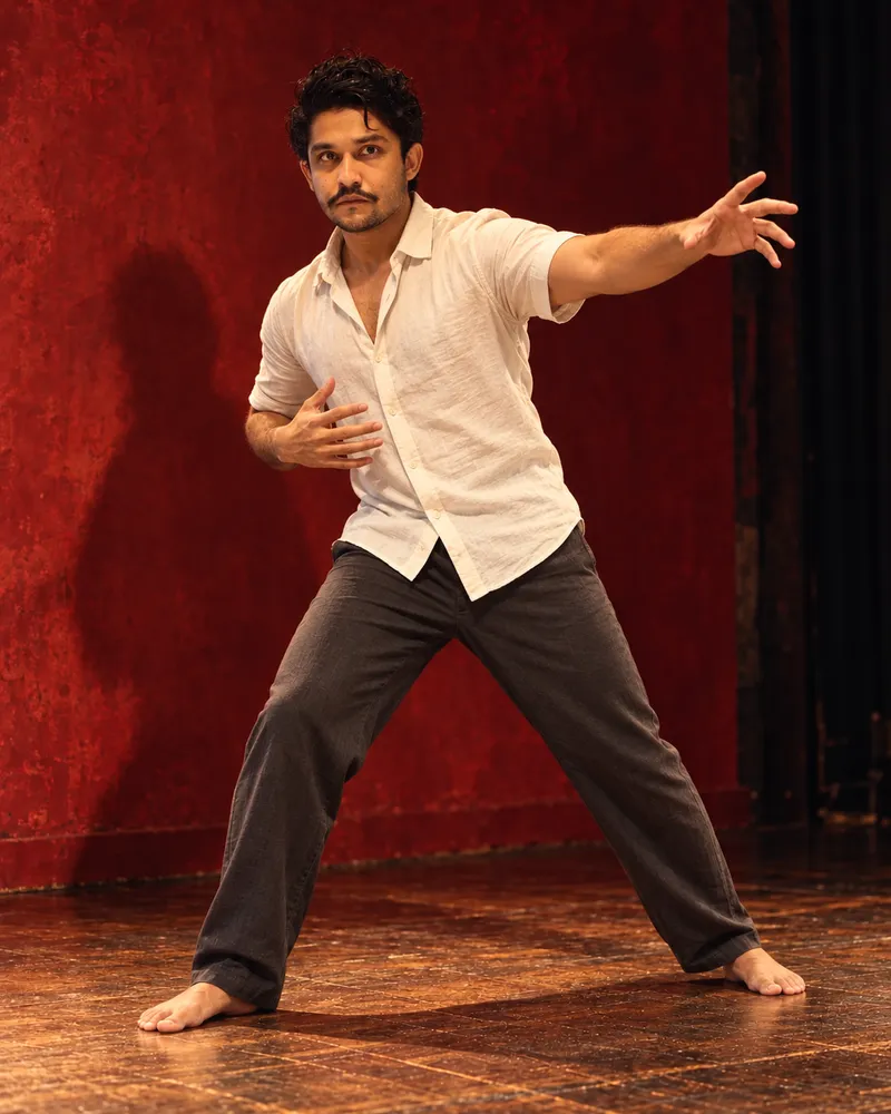 Saran Vashisht under red stage lighting
